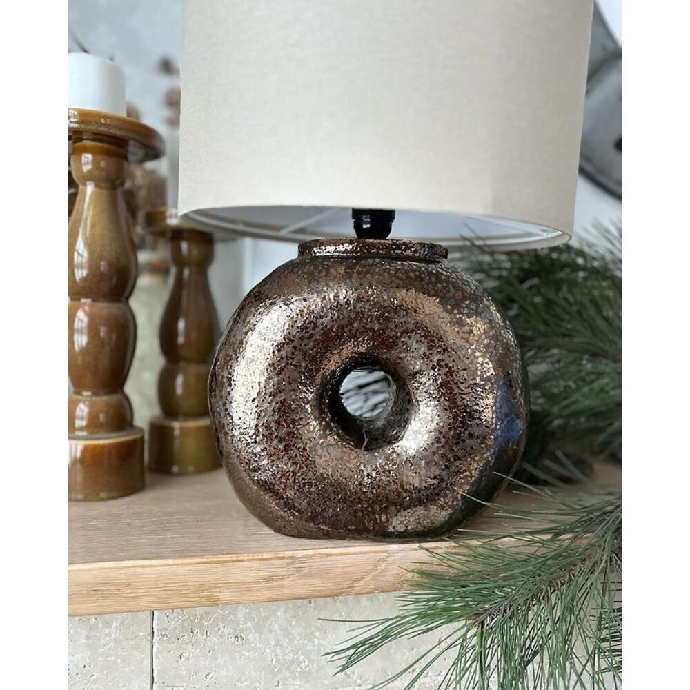 Ceramic table lamp on a brown shaped base in the shape of a bagel and a fabric lampshade 11887-yekeramika photo